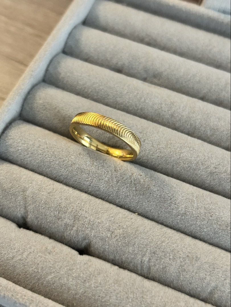 Catseye Band Ring (Category: Rings) located in Manila. Submitted by elonlineshop (Listing ID 1468500645, Image 3). Description: - Material/Color: Gold ring - Design: Textured ribbed pattern on top with a smooth polished inner band - Comfort: Smooth fit, great for all-day wear - Styling: Versatile piece, wear alone or stack with other rings - Condition: Clean finish, ready to wear -Stainless Steel.