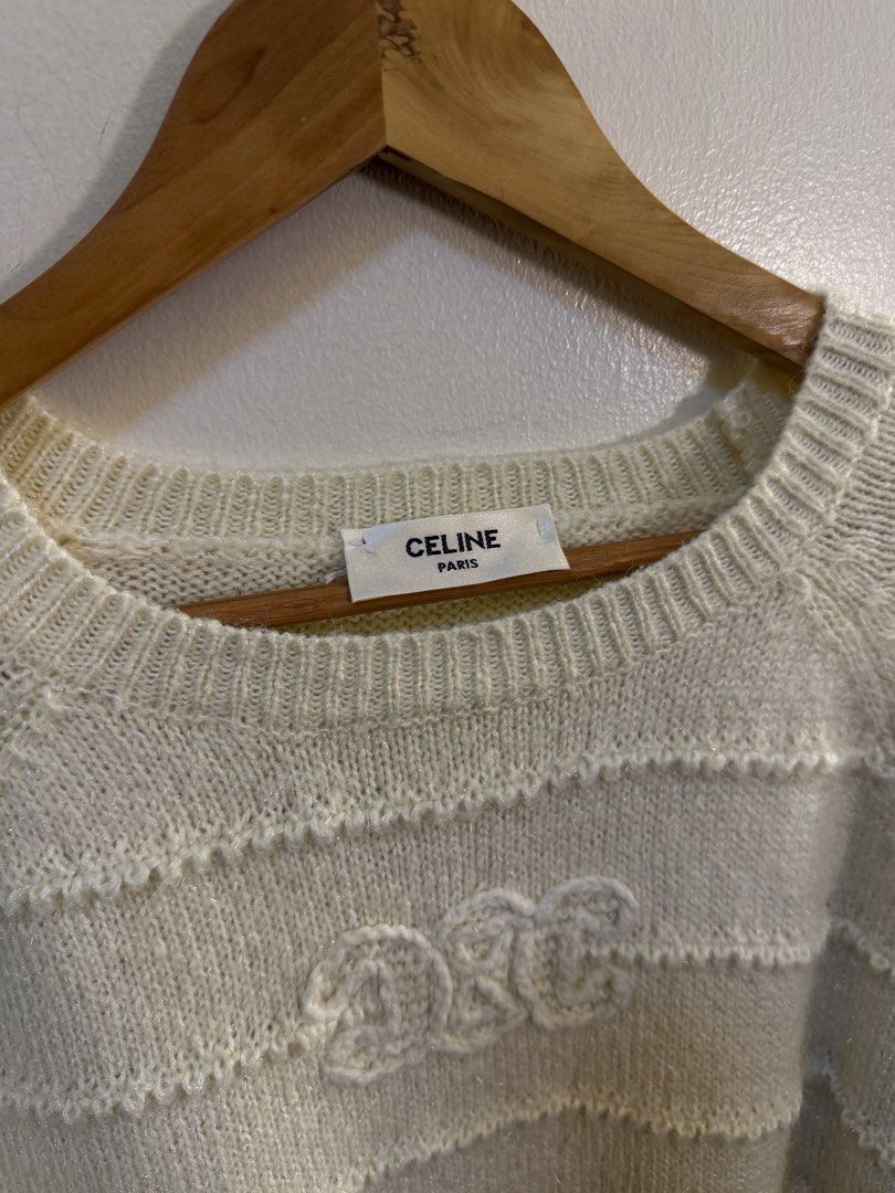 Celine Paris Off-White Striped Knit Sweater (Category: Longsleeves) located in Paranaque City. Submitted by mykapoynton (Listing ID 1468702792, Image 3). Description: - Brand: Celine Paris - Color: Cream - Material: Soft textured wool blend (warm and cozy) - Design: Horizontal ribbed stripes with embroidered chest logo - Fit/Style: Long raglan sleeves, ribbed crewneck, cuffs, and hem - Condition: Clean neckline tag attached, well-maintained.
