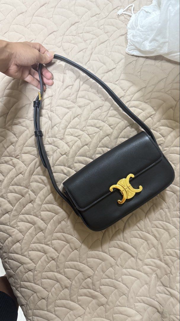 Celine Triomphe Black Leather Shoulder Bag (Category: Luxury Bags & Wallets) located in Makati City. Submitted by jianciee (Listing ID 1468509431, Image 3). Description: - Brand: Celine - Material: Premium black calfskin leather - Hardware: Elegant gold-tone hardware with front lock closure - Strap: Adjustable shoulder strap for versatile wear - Branding: Foil stamped logo under the front flap - Inclusions: Original white dust bag and paper tag i
