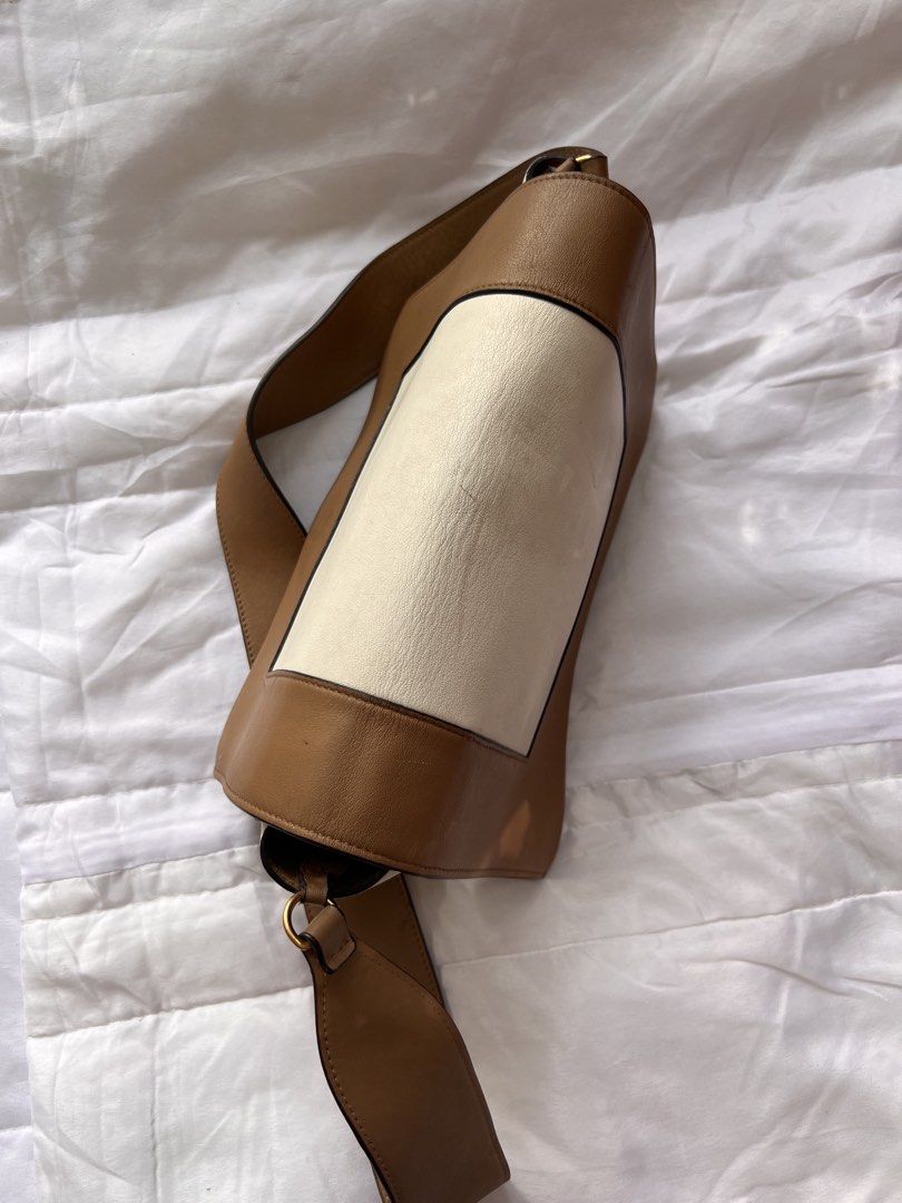 Celine Two-Tone Medium Soft Triomphe Shoulder Bag (Category: Luxury Bags & Wallets) located in Manila. Submitted by mightylion-ce6ea7 (Listing ID 1468523546, Image 3). Description: - Brand: Celine - Color: Tan and cream - Material: Premium leather - Hardware: Gold-tone - Design: Structured flap with front stamped Celine Paris logo - Strap: Thick, comfortable leather shoulder strap - Interior: Clean lining with zip closure, multiple compartments, 
