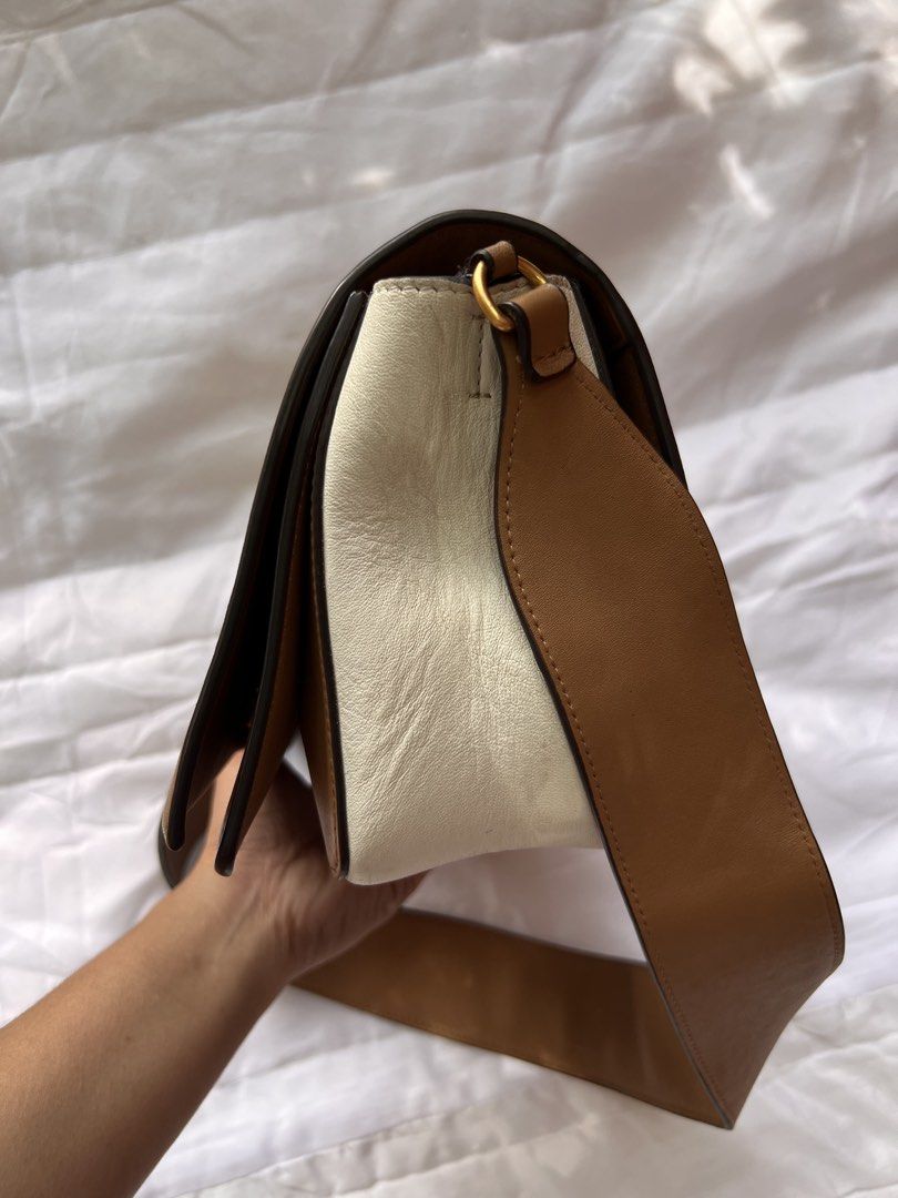 Celine Two-Tone Medium Soft Triomphe Shoulder Bag (Category: Luxury Bags & Wallets) located in Manila. Submitted by mightylion-ce6ea7 (Listing ID 1468523546, Image 2). Description: - Brand: Celine - Color: Tan and cream - Material: Premium leather - Hardware: Gold-tone - Design: Structured flap with front stamped Celine Paris logo - Strap: Thick, comfortable leather shoulder strap - Interior: Clean lining with zip closure, multiple compartments, 