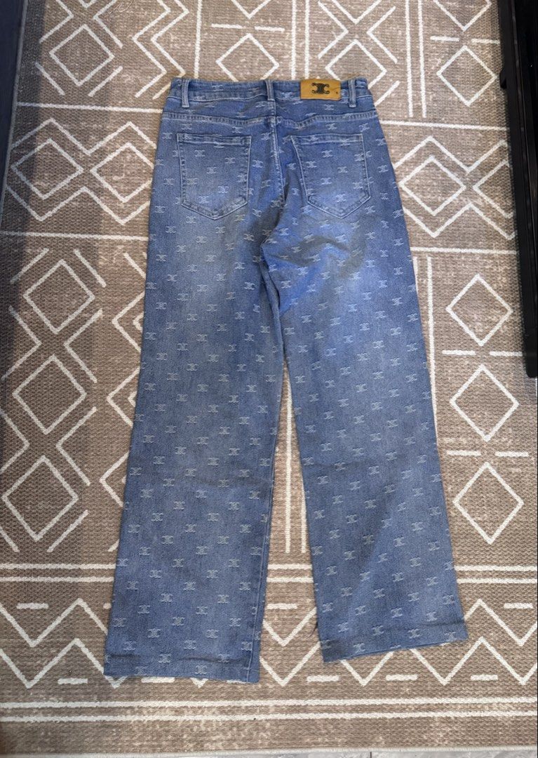 Challengers Crew Monogram Print Wide Leg Jeans (Category: Jeans) located in Bulacan. Submitted by zyannechlo86360 (Listing ID 1468550455, Image 2). Description: - Brand: Challengers Crew - Style: Light blue denim jeans with all-over monogram pattern, wide leg fit, and high waist - Closure: Unique multiple front button design with standard belt loops - Pockets: Two back pockets plus a branded rear waistband tag - Condition: Good pre-loved conditio