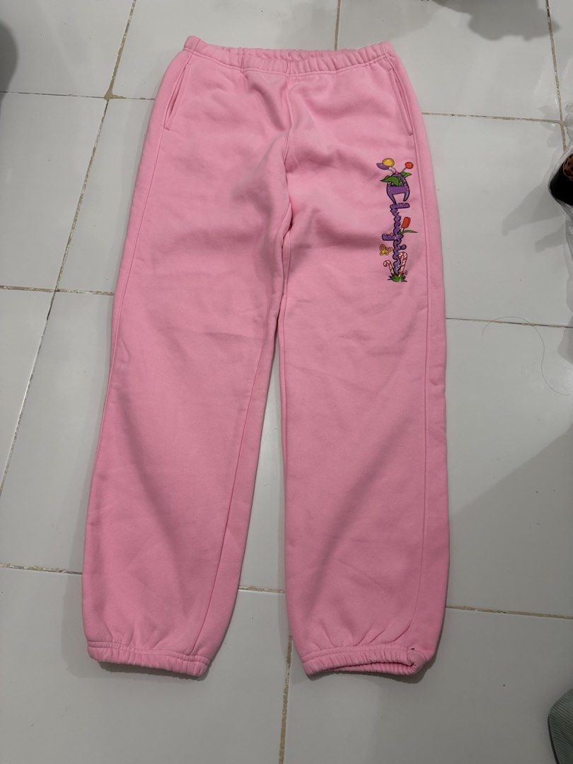 Champion Reverse Weave Candy Land Pink Sweatpants (Category: Other Bottoms) located in Manila. Submitted by xiestyleclothing (Listing ID 1468642433, Image 2). Description: - Brand: Champion Reverse Weave - Size: Medium - Color: Pink - Design: Vertical Candy Land graphics on left and lower right legs, with branding on the back pocket - Features: Elastic waistband, side pockets, and elastic ankle cuffs - Material: Cotton and polyester blend with a 