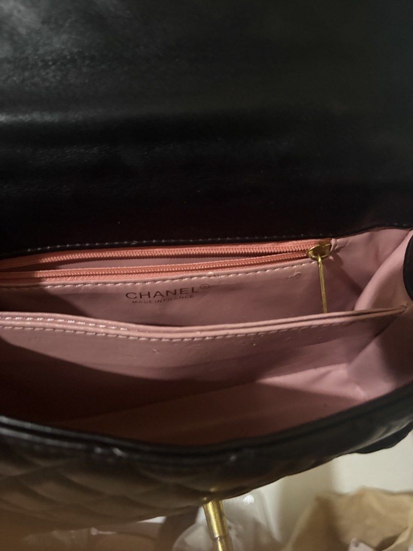 Chanel x Cambron OG cc underzip lambskin leather (Category: Luxury Bags & Wallets) located in Paranaque City. Submitted by GotUph (Listing ID 1468667853, Image 3). Description: - Brand: Chanel - Style: Quilted lambskin - Color: Classic black with pink interior lining - Handle: Coco handle bag super cool and unique multicolor stacked ring top handle - Strap: Included chain strap - Hardware: Gold-tone with iconic CC turn-lock closure - Interior: Zi