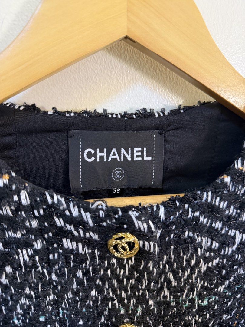CHANEL Black White Tweed Jacket Size 36 (Category: Coats, Jackets and Outerwear) located in Paranaque City. Submitted by mykapoynton (Listing ID 1468702106, Image 3). Description: - Brand: Chanel - Type: Tweed Jacket - Color: Black and White - Size: 36 (Made in France) - Details: Gold-tone CC buttons and chain accents on pockets - Fit: Clean silhouette, cropped length - Condition: Lined interior with brand tag and manufacturing labels intact.