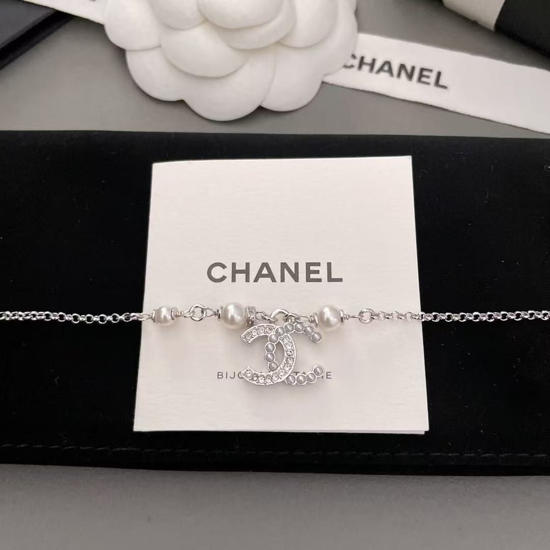 Chanel CC Pearl Crystal Silver Bracelet (Category: Bracelets) located in Pateros City. Submitted by purebird_714be0 (Listing ID 1468577608, Image 2). Description: - Authentic Chanel silver-tone chain bracelet - Features elegant pearl accents and a crystal-embedded interlocking CC charm - Adjustable length with a secure clasp closure - Includes complete original packaging: storage box, ribbon, paper bag, and felt pouch - Condition: Excellent, like