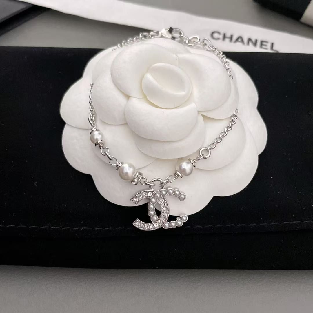 Chanel CC Pearl Crystal Silver Bracelet (Category: Bracelets) located in Pateros City. Submitted by purebird_714be0 (Listing ID 1468577608, Image 3). Description: - Authentic Chanel silver-tone chain bracelet - Features elegant pearl accents and a crystal-embedded interlocking CC charm - Adjustable length with a secure clasp closure - Includes complete original packaging: storage box, ribbon, paper bag, and felt pouch - Condition: Excellent, like