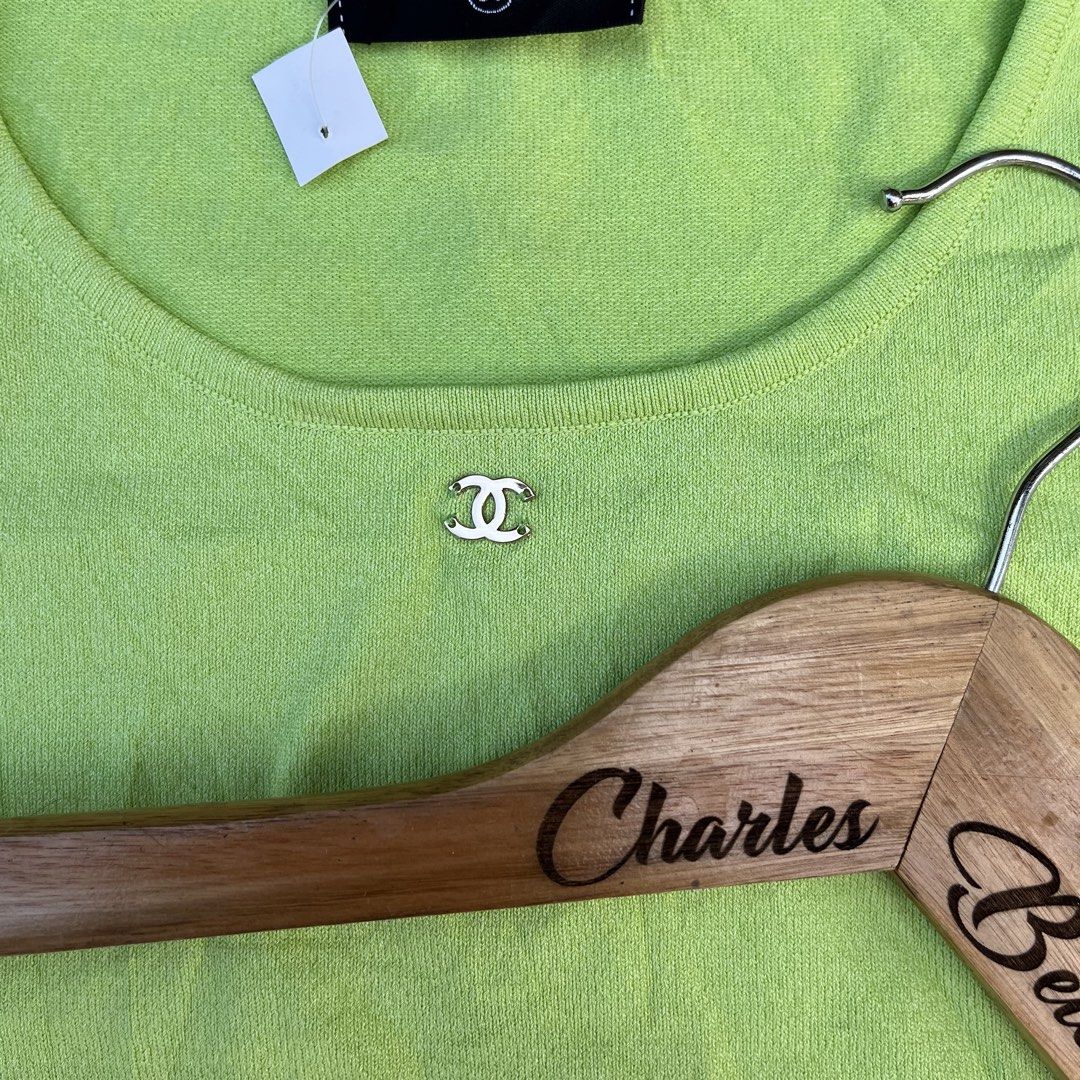 Chanel Lime Green Short Sleeve Knit Top (Category: Shirts) located in Davao. Submitted by charlesole52665 (Listing ID 1468555964, Image 2). Description: - Brand: Chanel - Item: Short sleeve knit top - Color: Lime green - Size: Tagged 38 (fits S-M) - Width: 15inch (stretchable) - Length: 21 inch - Details: Scoop neckline with metal CC logo charm, made in Italy - Material: Lightweight, stretch knit - Condition: Excellent, clean with no stains or pu