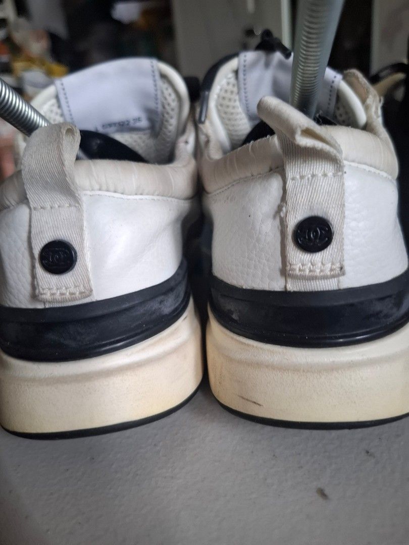 Chanel White and Black Sneakers (Category: Sneakers) located in Marikina City. Submitted by bags21.ph (Listing ID 1468503778, Image 2). Description: - Brand: Chanel Sneakers - Colorway: White, Black, and Beige - Materials: Mesh panels with leather and suede overlays - Branding: Iconic CC logo on the side, tongue label, heel pull tab buttons, and patterned outsole - Details: Black laces, clean white midsoles, and heel pull tabs - Condition: Shows 