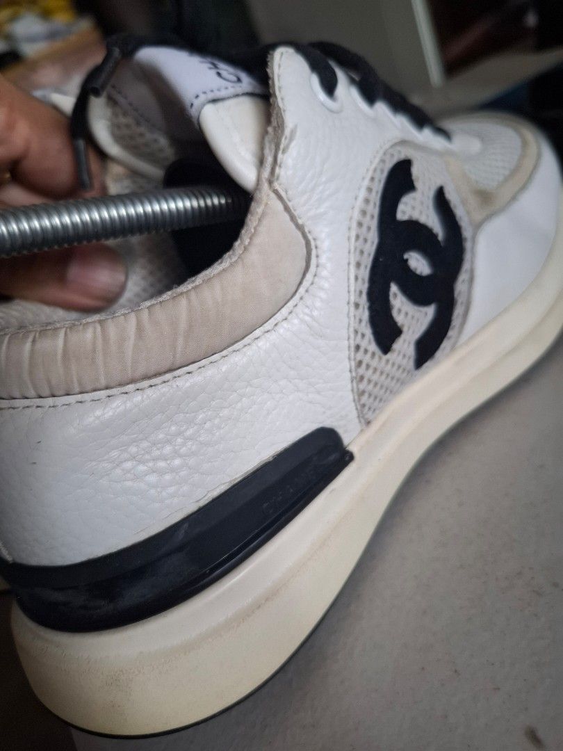 Chanel White and Black Sneakers (Category: Sneakers) located in Marikina City. Submitted by bags21.ph (Listing ID 1468503778, Image 3). Description: - Brand: Chanel Sneakers - Colorway: White, Black, and Beige - Materials: Mesh panels with leather and suede overlays - Branding: Iconic CC logo on the side, tongue label, heel pull tab buttons, and patterned outsole - Details: Black laces, clean white midsoles, and heel pull tabs - Condition: Shows 