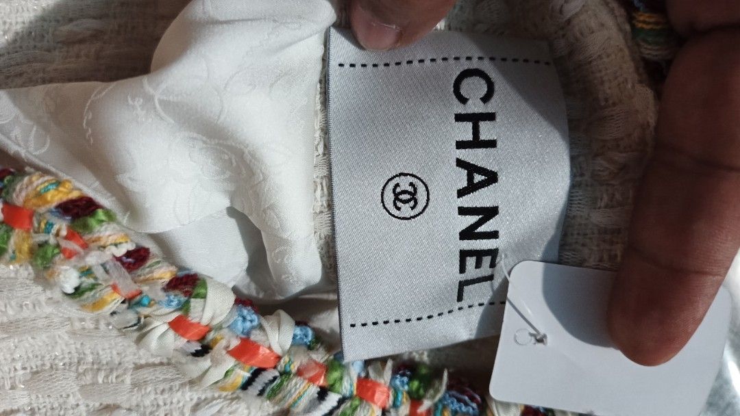 Chanel White Tweed Jacket Coat Wool Cotton (Category: Coats, Jackets and Outerwear) located in Makati City. Submitted by macdwyneki84361 (Listing ID 1468555430, Image 3). Description: - Authentic Chanel tweed jacket in elegant off-white - Premium blend of 50% wool and 50% cotton with 100% silk lining - Eye-catching multi-colored braided trim along edges, collar, and pockets - Signature quilted metal CC buttons on front closure and four patch pock