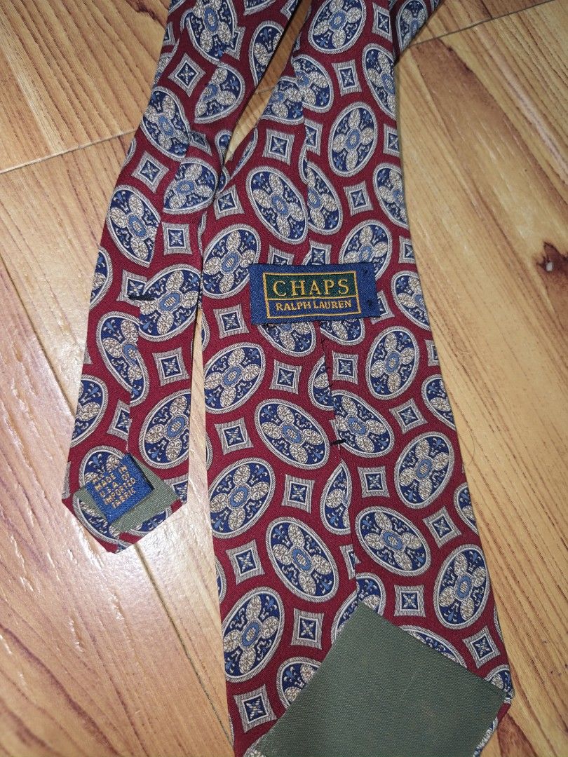 Chaps Ralph Lauren Silk Tie Burgundy Medallion Pattern (Category: Ties) located in Pasay City. Submitted by menard_jacob (Listing ID 1468582671, Image 3). Description: - Brand: Chaps Ralph Lauren - Design: Burgundy with blue and beige medallion pattern - Origin: Made in USA with imported fabric - Fit: Standard width and length - Condition: Clean, excellent, and ready to wear for work or formal events ₱550 Free Shipping 📩📩📩.