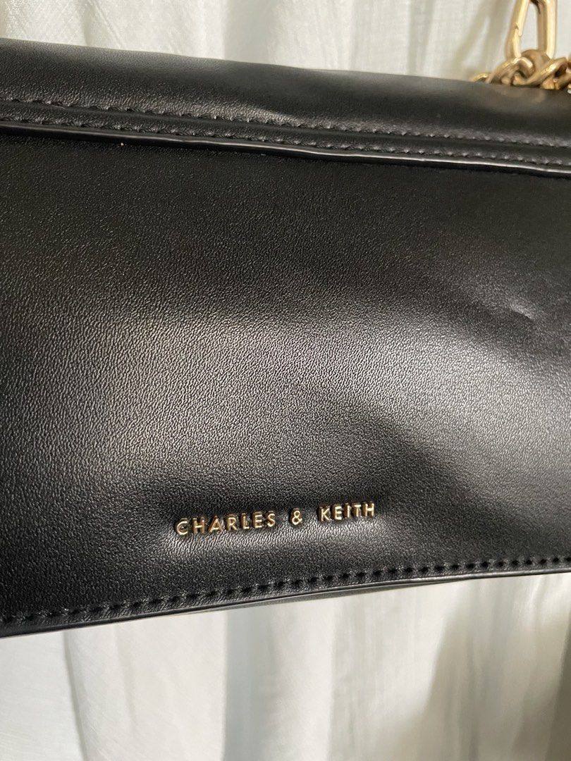 Charles & Keith Black Envelope Chain Bag (Category: Shoulder Bags) located in Cabanatuan. Submitted by moraiahraven (Listing ID 1468575664, Image 3). Description: Stylish black Charles & Keith envelope bag with gold-tone chunky chain. Details: • Classic envelope flap design • Smooth black exterior • Gold-tone hardware • Embossed “CHARLES & KEITH” logo on front flap and interior • Can be worn 2 ways: • Long black adjustable leather strap (crossbod