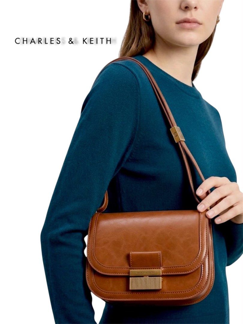 Charles & Keith Brown Shoulder Bag (Category: Shoulder Bags) located in Cebu City. Submitted by gabgaaab (Listing ID 1468680353, Image 1). Description: - Charles & Keith Brown Shoulder Bag - Excellent Condition - Color: Rich brown - Design: Structured saddle bag with double gusset sides and clean leather-like finish - Adjustable strap for shoulder or crossbody wear - Actual Pics Posted.