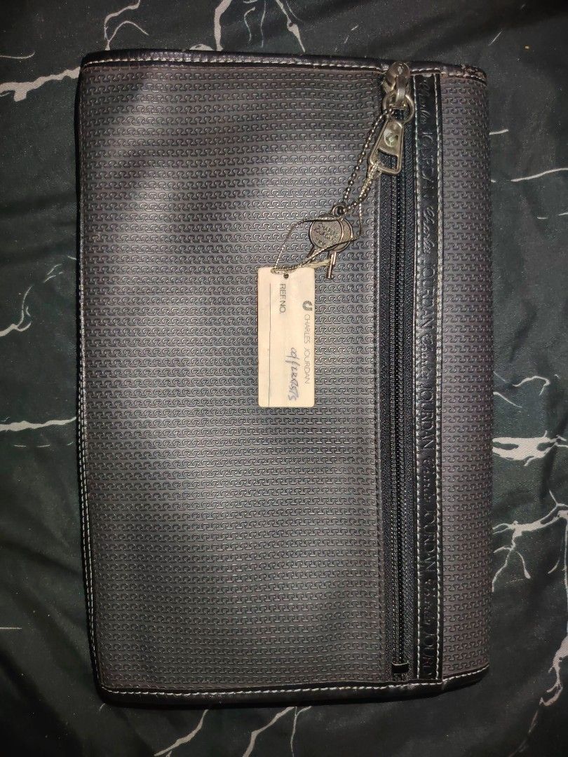 Charles Jourdan Actif Document Organiser (Category: Stationery & School Supplies) located in Manila. Submitted by chuaniki (Listing ID 1468709078, Image 3). Description: - Authentic Charles Jourdan Actif organiser from Paris - Classic monogram pattern printed on the exterior - Front flap closure featuring debossed branding - Convenient zip pocket on the back - Stylish hanging keys attached via chain - Grey fabric-lined interior with a zip pocket 
