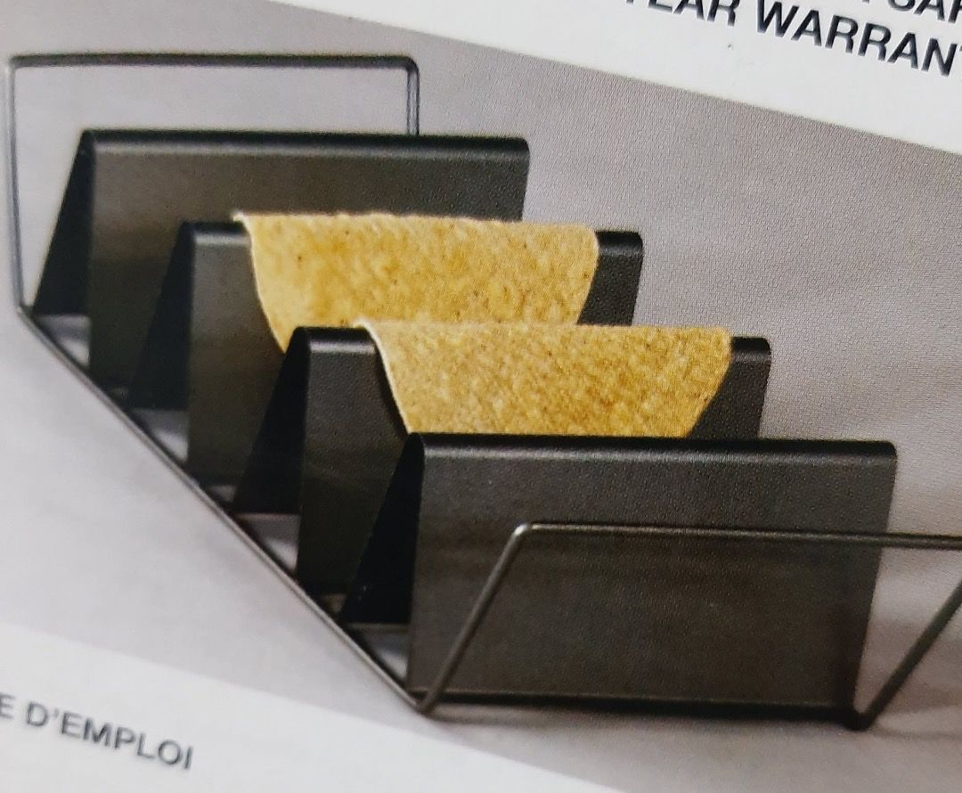 Chicago Metallic Non-Stick Baked Taco Rack (Category: Cookware & Accessories) located in Cabanatuan. Submitted by aralets (Listing ID 1468706348, Image 2). Description: - Brand: Chicago Metallic - Holds four 6-inch round taco shells for easy oven baking - Non-stick metal construction with a sleek dark finish - Ideal for homemade Taco Tuesday nights Comes in the original box (box shows minor wear).
