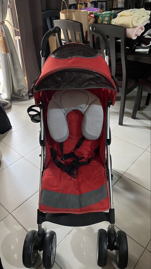 Chicco Red Stroller with Footmuff and Head Support (Category: Strollers) located in Pasig City. Submitted by maria_coffee (Listing ID 1468611562, Image 2). Description: - Brand: Chicco - Color: Red and grey - Condition: Clean and ready for use - Includes: Matching footmuff cover and grey neck support pillow - Canopy: Features a dark window panel on top - Wheels: Multi-wheel setup with dual front and rear wheels - Location: Santolan, Pasig City - 