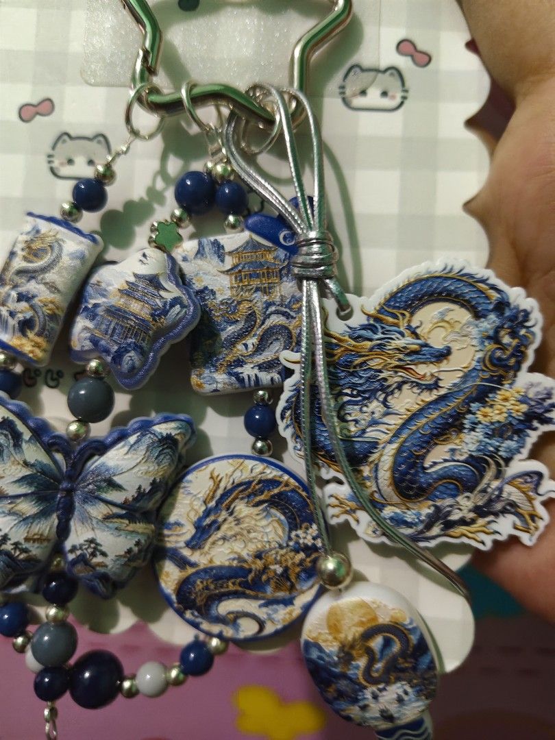 Chinese Dragon Butterfly Keychain (Category: Charms) located in Rizal. Submitted by yves1211 (Listing ID 1468670127, Image 3). Description: - Blue and white beads design with intricate traditional motifs - Features detailed dragon and butterfly charms with gold accents - Includes decorative beads and a secure silver star-shaped clasp - Comes on a decorative backing card, great for gifting - Versatile accessory for bags, keys, or wallets.