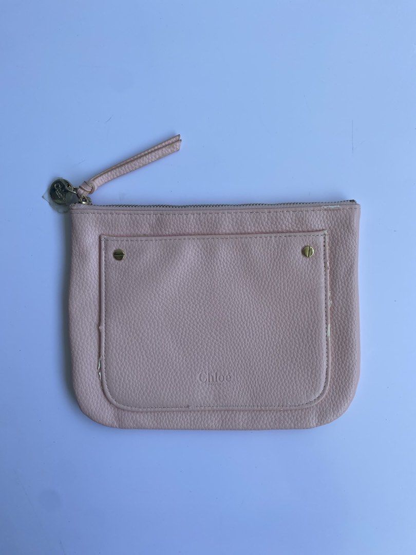 Chloé Parfum Pink Pouch Makeup Bag (Category: Purses & Pouches) located in Cavite. Submitted by benta_bounce (Listing ID 1468556928, Image 1). Description: - Authentic Chloé Parfum pink pouch - Features chic gold-tone hardware and debossed logo text on the front - Zipper closure with a matching pull tab and branded metal charm (protective plastic still attached) - Includes a convenient front pocket - Flaw note: Some peeling and cracking along the