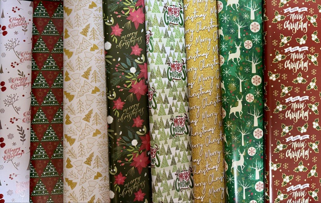 Christmas Holiday Wrapping Paper Assorted Designs (Category: Craft Supplies & Tools) located in Quezon City. Submitted by kryshnanzyanna (Listing ID 1468523023, Image 1). Description: - Brand new, unused Christmas wrapping paper - Features festive designs including trees, snowflakes, berries, and Merry Christmas text - Beautiful holiday color scheme: gold trees on white, classic red with script, and green trees - Ideal for holiday gift-giving and