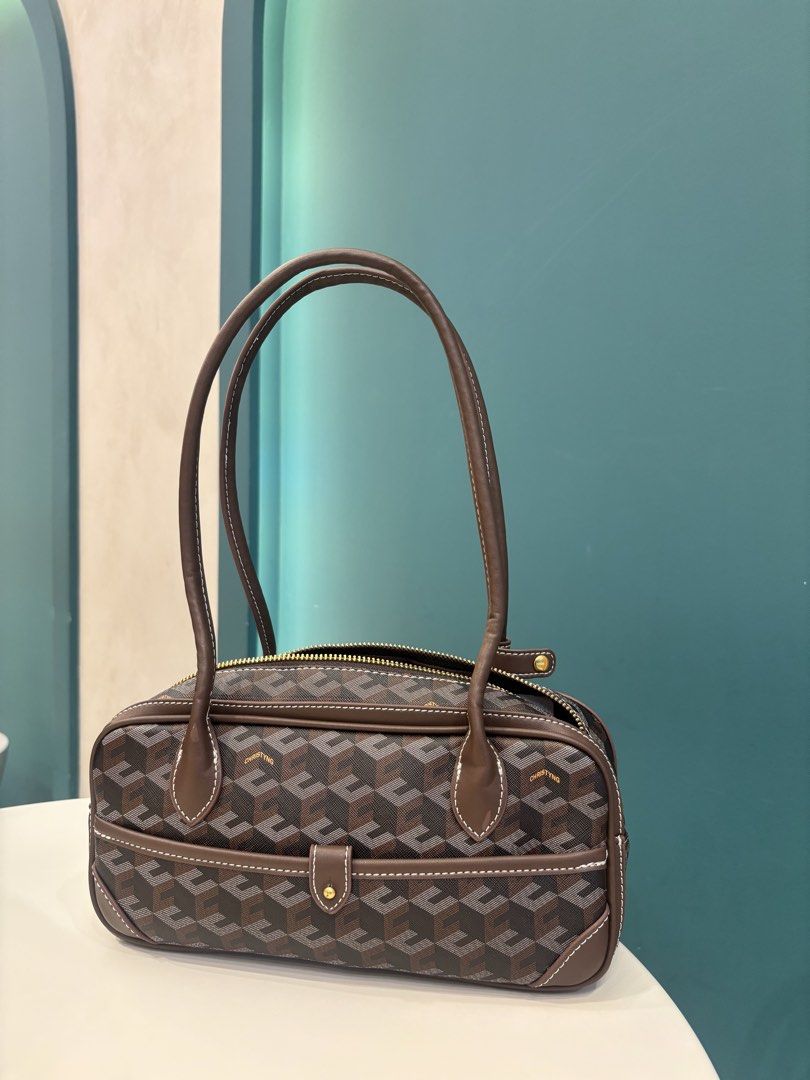 Christy Ng brown geometric patterned shoulder bag (Category: Shoulder Bags) located in Paranaque City. Submitted by ciangggg (Listing ID 1468662953, Image 3). Description: - Brand: Christy Ng - Style: Geometric print shoulder bag in brown - Condition: Brand new with tags attached - Closure: Secure top zip closure - Pockets: Front slip pocket with snap tab closure - Details: Contrasting white stitching on brown trim, dark hardware, and clean inter