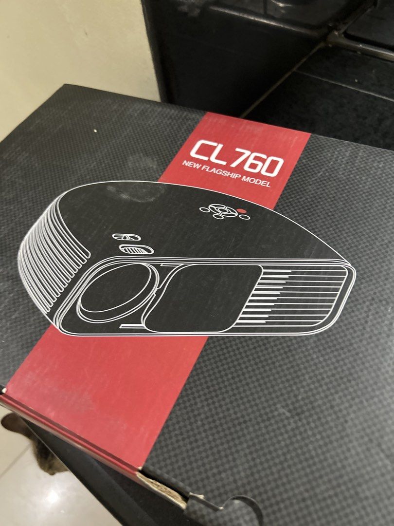 CL 760 Projector New Flagship Model (Category: Projectors) located in San Fernando. Submitted by TheBTBs (Listing ID 1468682255, Image 1). Description: - Model: CL 760 Projector (Black) - Condition: Clean physical condition, well-kept in original packaging - Packaging: Original box complete with protective foam inserts - Controls: Convenient top control buttons (Power, Source, Menu, Navigation ring) - Adjustments: Easy-to-use manual focus and key