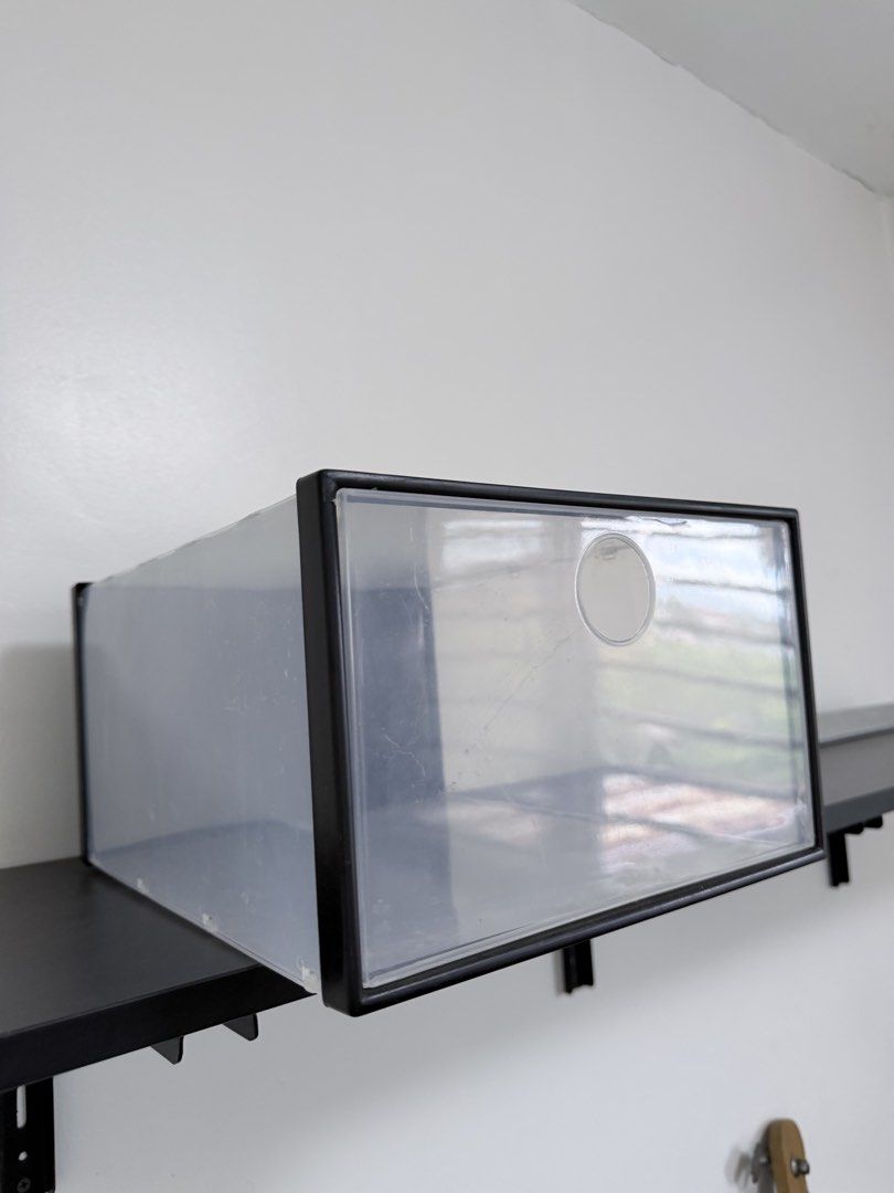Clear Plastic Shoe Storage Box with Black Frame (Category: Storage Boxes & Baskets) located in Quezon City. Submitted by yourprelovedhub (Listing ID 1468557861, Image 3). Description: - Drop-front door with clear plastic for easy viewing - Sturdy black frame with built-in ventilation hole - Stackable design to save space and organize shelves - Dust-proof construction keeps footwear clean - Clean minimalist look perfect for closets and entryways -