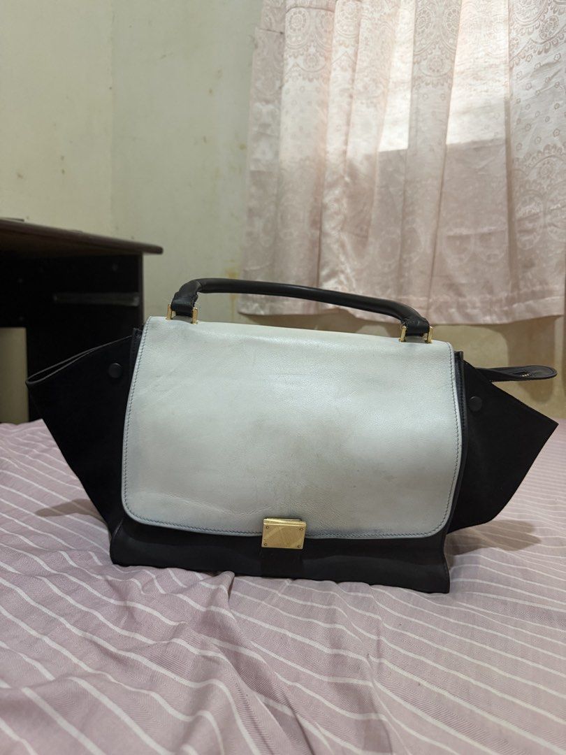 Céline Trapeze Bag Black and Light Blue (Category: Luxury Bags & Wallets) located in Minglanilla. Submitted by twodegrees (Listing ID 1468567315, Image 2). Description: - Brand: Céline - Style: Trapeze Bag - Materials: Black leather and suede with light blue flap - Hardware: Gold-tone with engraved logo lock - Interior: Suede lining with slip pockets (Made in Italy stamp) - Features: Top handle and expandable side wings - Condition: Noticeable sc
