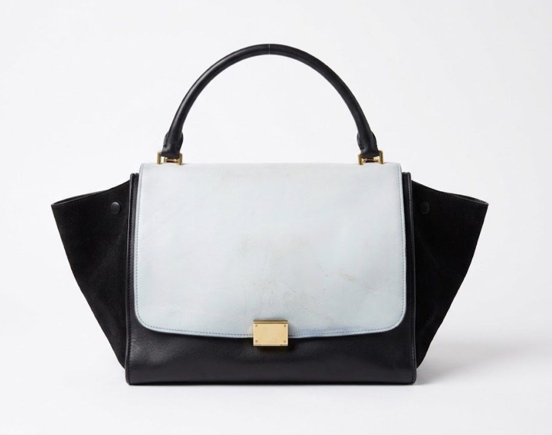 Céline Trapeze Bag Black and Light Blue (Category: Luxury Bags & Wallets) located in Minglanilla. Submitted by twodegrees (Listing ID 1468567315, Image 1). Description: - Brand: Céline - Style: Trapeze Bag - Materials: Black leather and suede with light blue flap - Hardware: Gold-tone with engraved logo lock - Interior: Suede lining with slip pockets (Made in Italy stamp) - Features: Top handle and expandable side wings - Condition: Noticeable sc