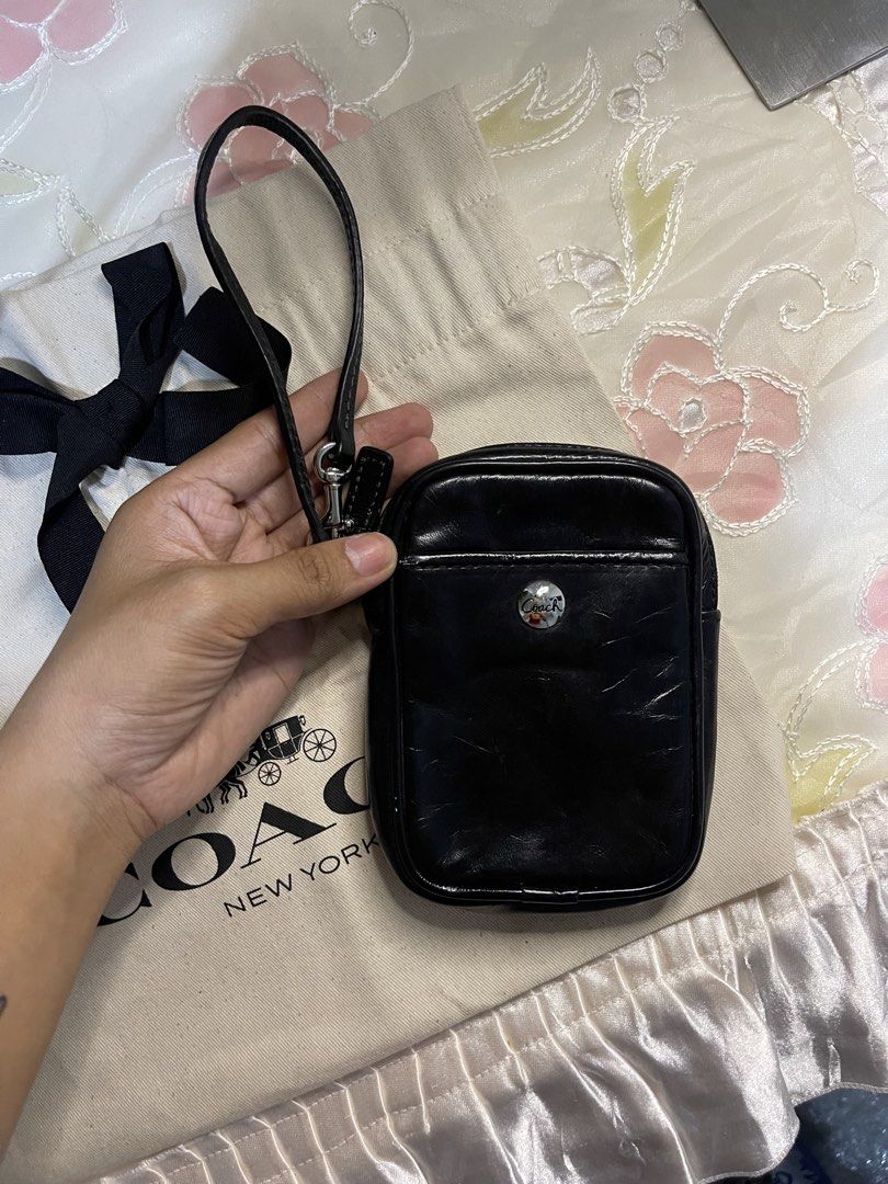 Coach Black Leather Wristlet Pouch (Category: Purses & Pouches) located in Dumaguete. Submitted by braveforest-2a12 (Listing ID 1468647971, Image 3). Description: - Authentic Coach black leather wristlet pouch - Secure zip top closure with convenient wrist strap - Front slip pocket accented with a silver Coach button - Roomy interior fits cards, keys, and small essentials - Includes original dust bag with attached black ribbon.