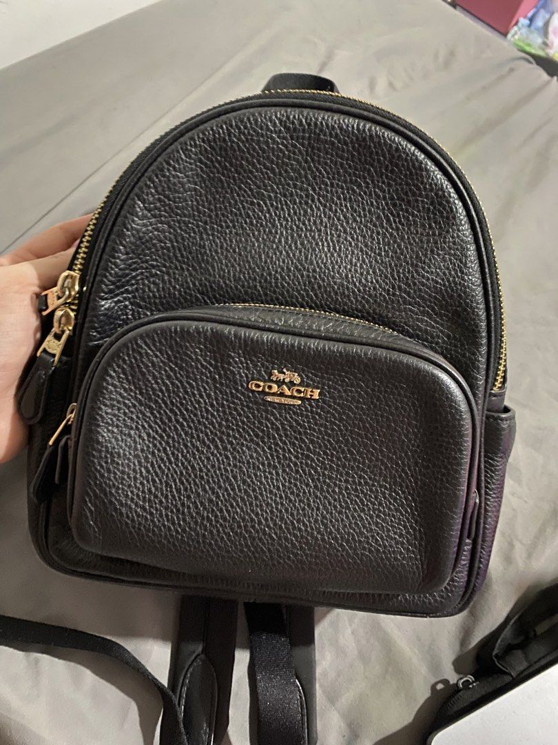 Coach Black Pebbled Leather Mini Backpack Gold Hardware (Category: Luxury Bags & Wallets) located in General Trias. Submitted by sora_mekaru (Listing ID 1468542425, Image 1). Description: - Authentic Coach backpack in black pebbled leather - Elegant gold-tone hardware throughout - Front zip pocket with Coach logo lettering and horse and carriage emblem - Secure dual-zip main compartment with fabric-lined interior - Handy inner zippered pocket for