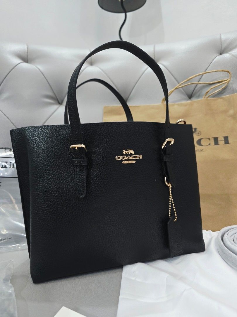 Coach Black Tote Bag with Red Interior (Category: Tote Bags) located in Marikina City. Submitted by jemalynpdc77 (Listing ID 1468584854, Image 3). Description: M0IIiE Tote Bag Ready to Ship 😍 Complete Inclusions 3-way tote bag (with extra straps) Measurements Length: 9.75" Height: 7.5" Width: 4.75" Materials Double face leather and polished pebble leather Fabric lining Handle Handles with 4.75" drop Strap Detachable strap with 22" drop for shoul