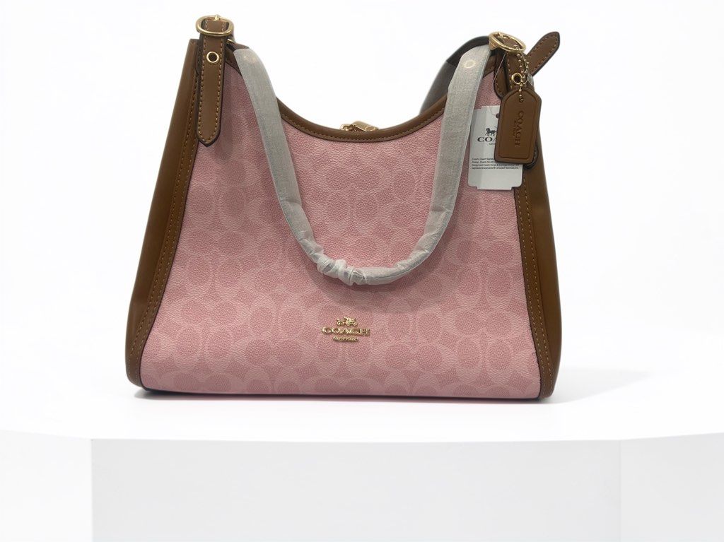 Coach Erin Pink Shoulder Bag (Category: Shoulder Bags) located in Quezon City. Submitted by emjen (Listing ID 1468526330, Image 1). Description: -Coach shoulder bag in pink signature coated canvas - Features stylish brown leather trim and gold-tone hardware - Includes hanging leather logo tag and product tag - Secure zip-top closure with a clean, spacious interior and exterior - Straight from retail packaging, ready to gift or use! Within BULACAN