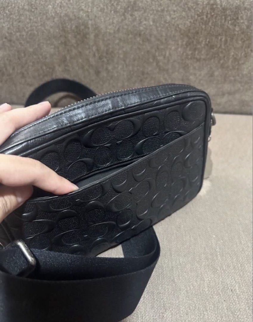 Coach Monogram Crossbody Sling bag (Category: Sling Bags) located in Subic. Submitted by declutterbyshit (Listing ID 1468502833, Image 2). Description: - Authentic Coach Graham Crossbody Bag (Model F50713) - Color: Black leather with debossed signature monogram pattern - Secure top zip closure with dark hardware and leather pull - Adjustable fabric strap for a comfortable, custom fit - Interior lined with fabric, featuring a handy slip pocket and