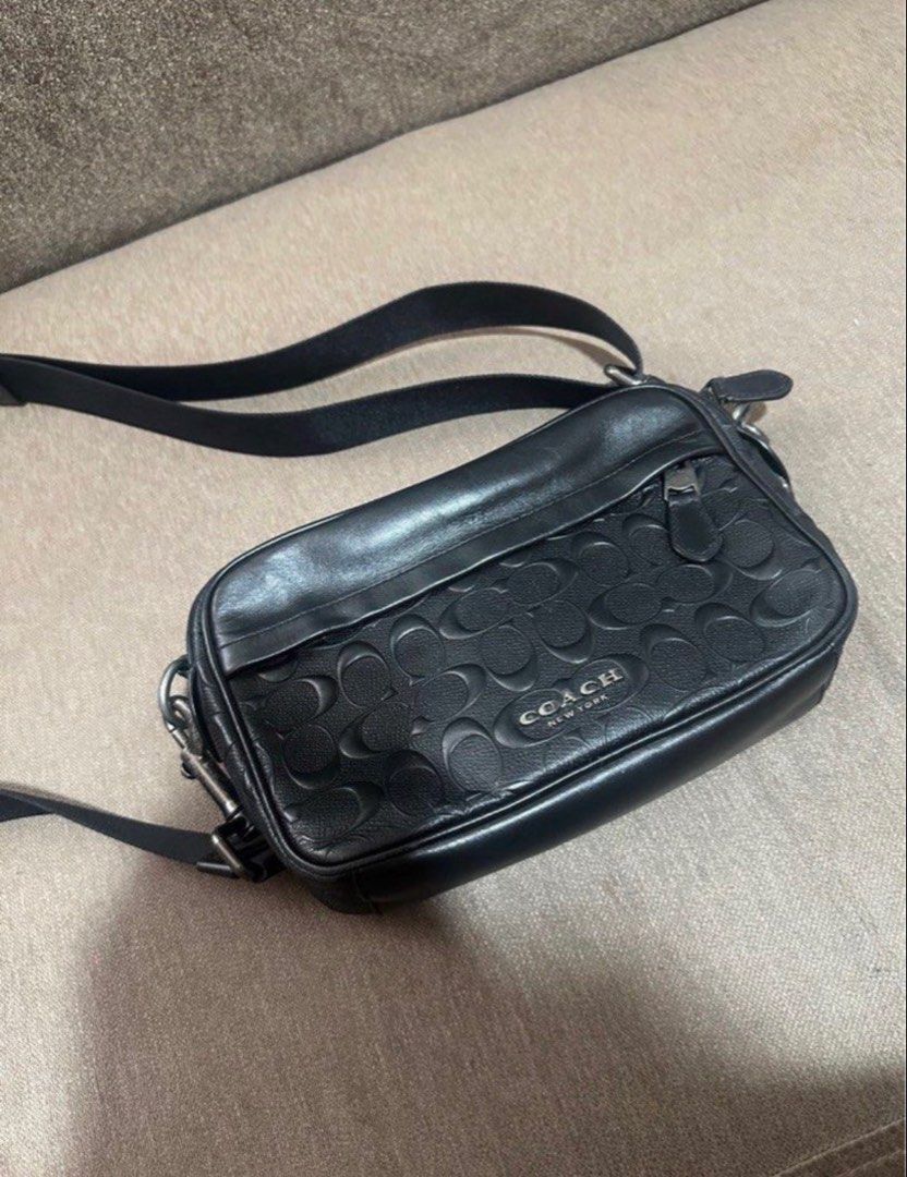 Coach Monogram Crossbody Sling bag (Category: Sling Bags) located in Subic. Submitted by declutterbyshit (Listing ID 1468502833, Image 1). Description: - Authentic Coach Graham Crossbody Bag (Model F50713) - Color: Black leather with debossed signature monogram pattern - Secure top zip closure with dark hardware and leather pull - Adjustable fabric strap for a comfortable, custom fit - Interior lined with fabric, featuring a handy slip pocket and