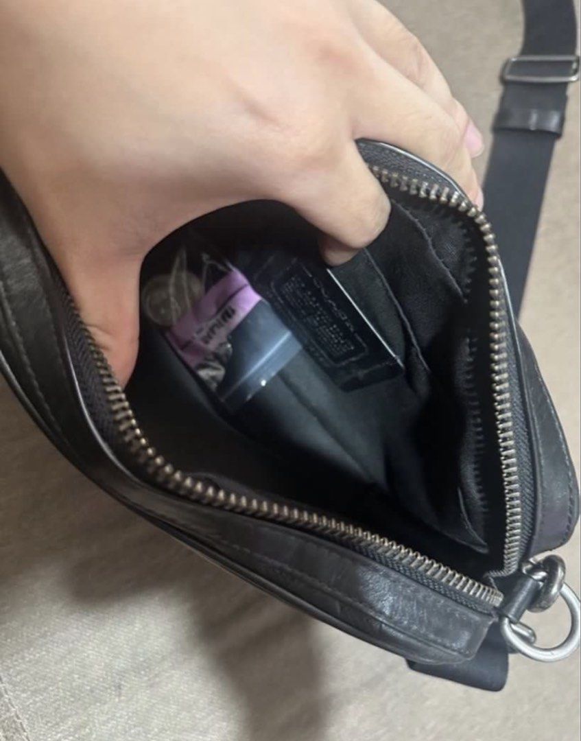 Coach Monogram Crossbody Sling bag (Category: Sling Bags) located in Subic. Submitted by declutterbyshit (Listing ID 1468502833, Image 3). Description: - Authentic Coach Graham Crossbody Bag (Model F50713) - Color: Black leather with debossed signature monogram pattern - Secure top zip closure with dark hardware and leather pull - Adjustable fabric strap for a comfortable, custom fit - Interior lined with fabric, featuring a handy slip pocket and