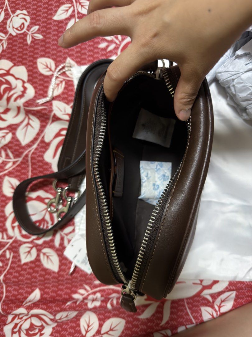 Coach Radio Camera Bag (Category: Luxury Bags & Wallets) located in Mabalacat. Submitted by madsnicdao (Listing ID 1468598412, Image 2). Description: Original price at Php 19,500 Selling at Php 10,000 Maple in Color Natural grain leather Inside snap pocket Zip closure, fabric lining Outside magnetic snap pocket Detachable strap with 55cm drop for shoulder or crossbody wear 23cm (L) x 15cm (H) x 6.5cm (W).