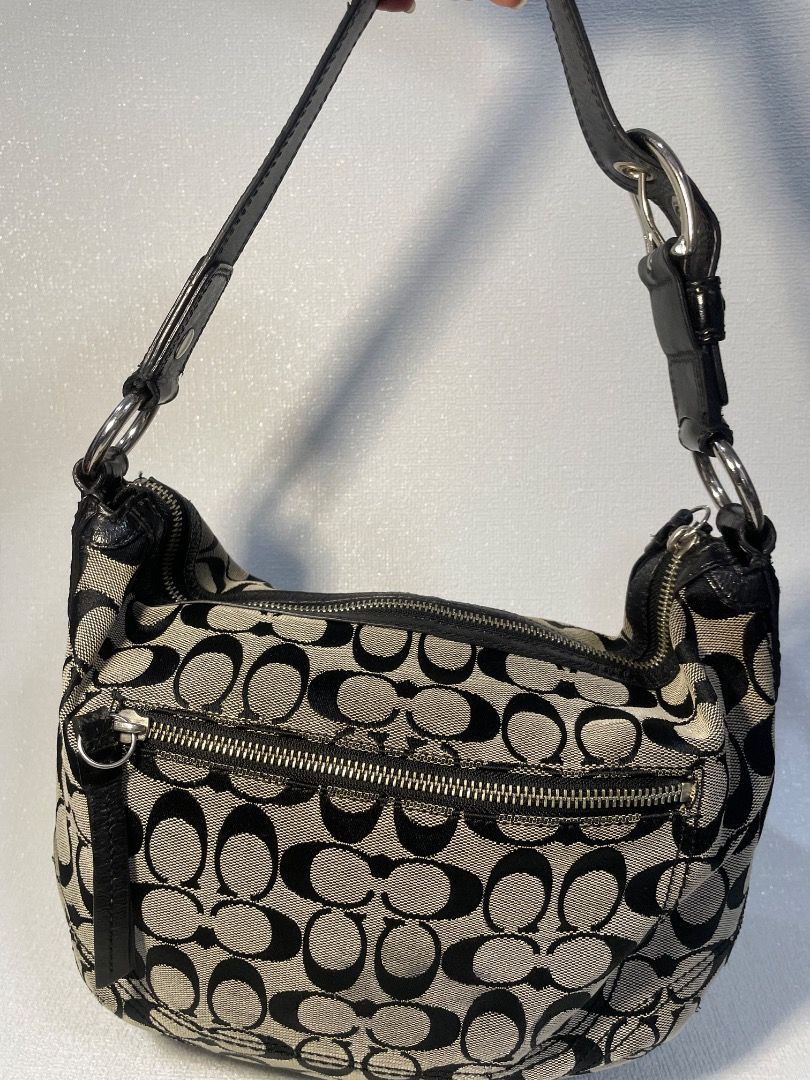 Coach Soho Signature Jacquard Medium Hobo (Category: Luxury Bags & Wallets) located in Manila. Submitted by tshoponline (Listing ID 1468299572, Image 3). Description: Black and white Coach signature C jacquard shoulder bag. Black leather strap with silver hardware buckle. Zip top closure. Clean fabric lining inside. Classic y2k style hobo purse, spacious enough for daily essentials. Coach Soho Signature Jacquard Medium Hobo •2008 - Style no. F131