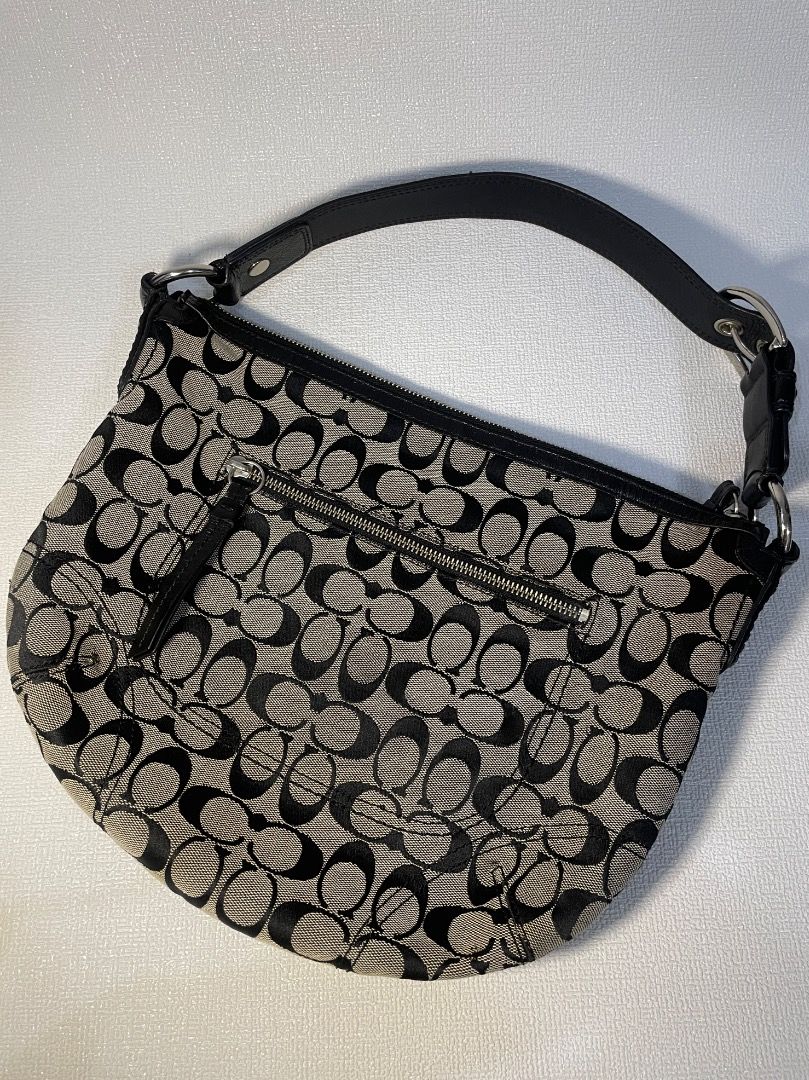 Coach Soho Signature Jacquard Medium Hobo (Category: Luxury Bags & Wallets) located in Manila. Submitted by tshoponline (Listing ID 1468299572, Image 2). Description: Black and white Coach signature C jacquard shoulder bag. Black leather strap with silver hardware buckle. Zip top closure. Clean fabric lining inside. Classic y2k style hobo purse, spacious enough for daily essentials. Coach Soho Signature Jacquard Medium Hobo •2008 - Style no. F131