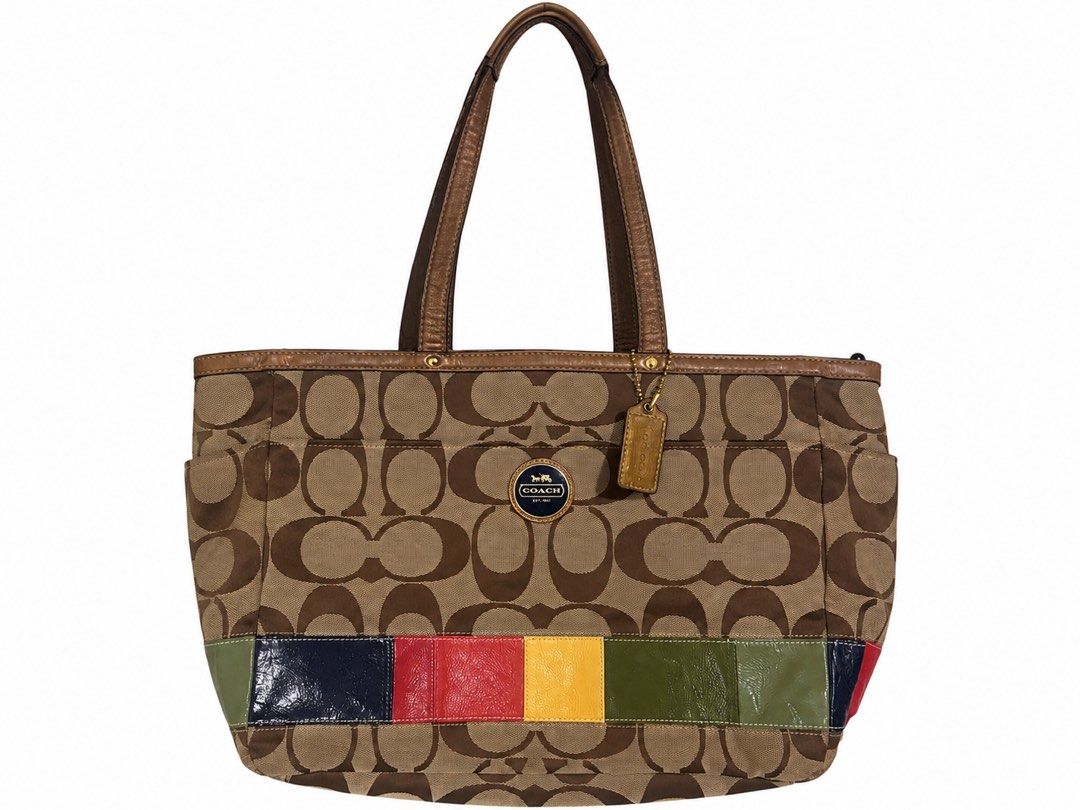 Coach Signature Stripe Patchwork Tote Bag (Category: Tote Bags) located in Manila. Submitted by happywind_ba7b96 (Listing ID 1468529119, Image 1). Description: - Authentic Coach signature C canvas tote bag - Eye-catching multi-color patent leather bottom stripes - Stylish metallic bronze leather handles and matching hangtag - Luxurious navy blue satin lining with zipper and slip compartments - Elegant gold-tone hardware details - Spacious design 