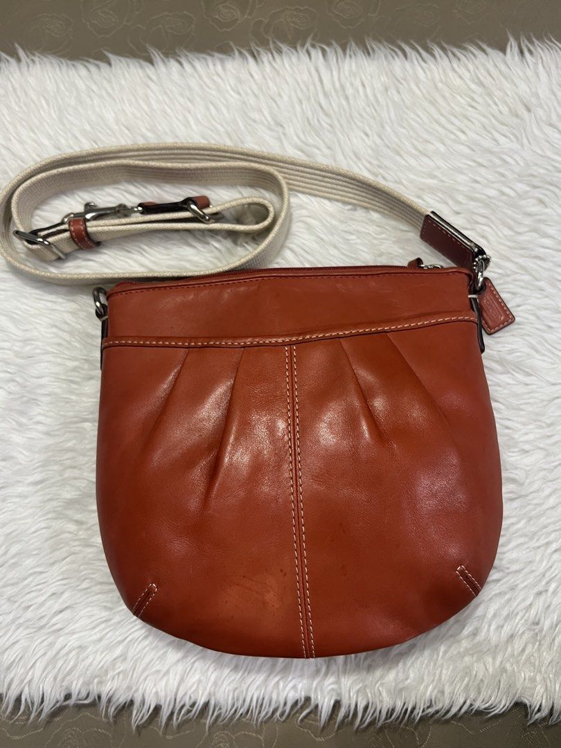 Coach Sling Bag (Category: Cross-body Bags) located in General Trias. Submitted by mybag2025 (Listing ID 1468649984, Image 1). Description: Red orange color Fits phone.