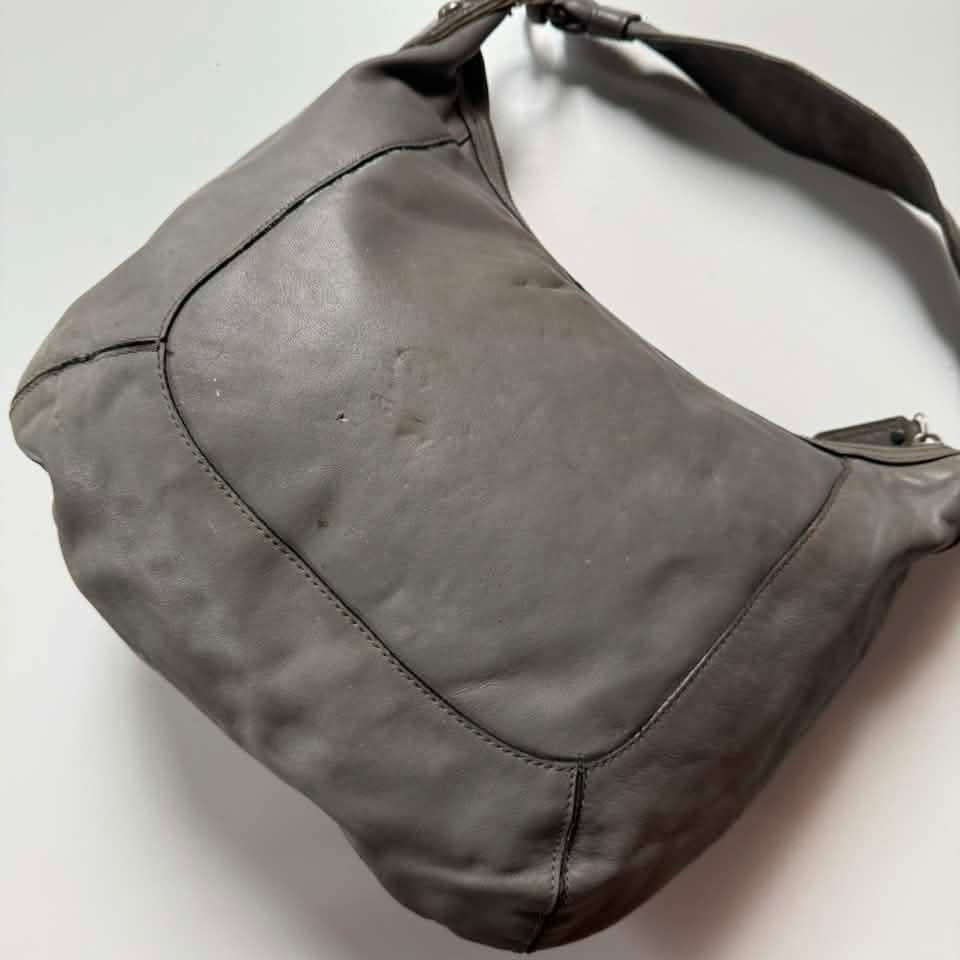 Coach Y2K Leather Hobo Bag (Category: Luxury Bags & Wallets) located in Bacolod. Submitted by lux.antithrifts (Listing ID 1468646265, Image 3). Description: Brand & Silhouette: Vintage Coach slouchy shoulder/hobo bag. Materials & Textures: Main Body: Soft, supple grey leather. Trim Accents: Embossed faux-crocodile leather lower panel with olive/tan glossy patent leather piping and suede border framing. Hardware & Closure: Heavy brushed nickel/sil
