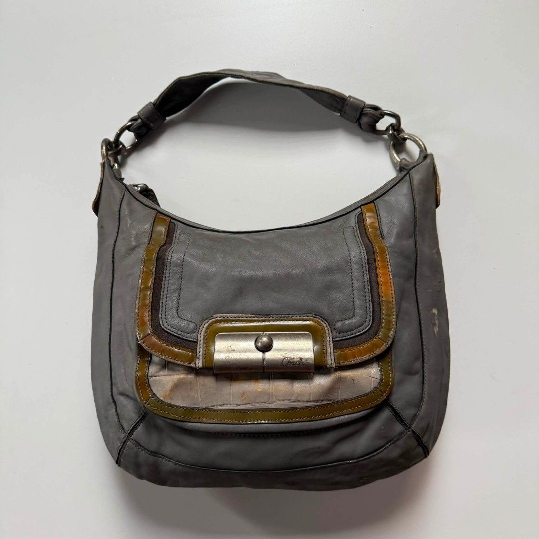 Coach Y2K Leather Hobo Bag (Category: Luxury Bags & Wallets) located in Bacolod. Submitted by lux.antithrifts (Listing ID 1468646265, Image 1). Description: Brand & Silhouette: Vintage Coach slouchy shoulder/hobo bag. Materials & Textures: Main Body: Soft, supple grey leather. Trim Accents: Embossed faux-crocodile leather lower panel with olive/tan glossy patent leather piping and suede border framing. Hardware & Closure: Heavy brushed nickel/sil