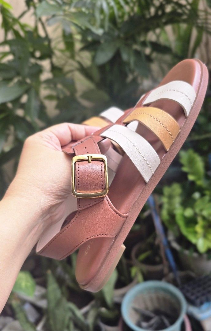 Cole Haan Multi-Color Leather Flat Sandals (Category: Flats & Sandals) located in Quezon City. Submitted by momof3_11 (Listing ID 1468514264, Image 3). Description: - Brand: Cole Haan - Type: Flat sandals - Material: Brown, white, and tan leather straps - Closure: Gold-tone buckle at the ankle - Details: Clean footbeds with embossed gold logo lettering - Condition: Comfortable flat sole with light wear on the bottom tread - Style: Great option fo