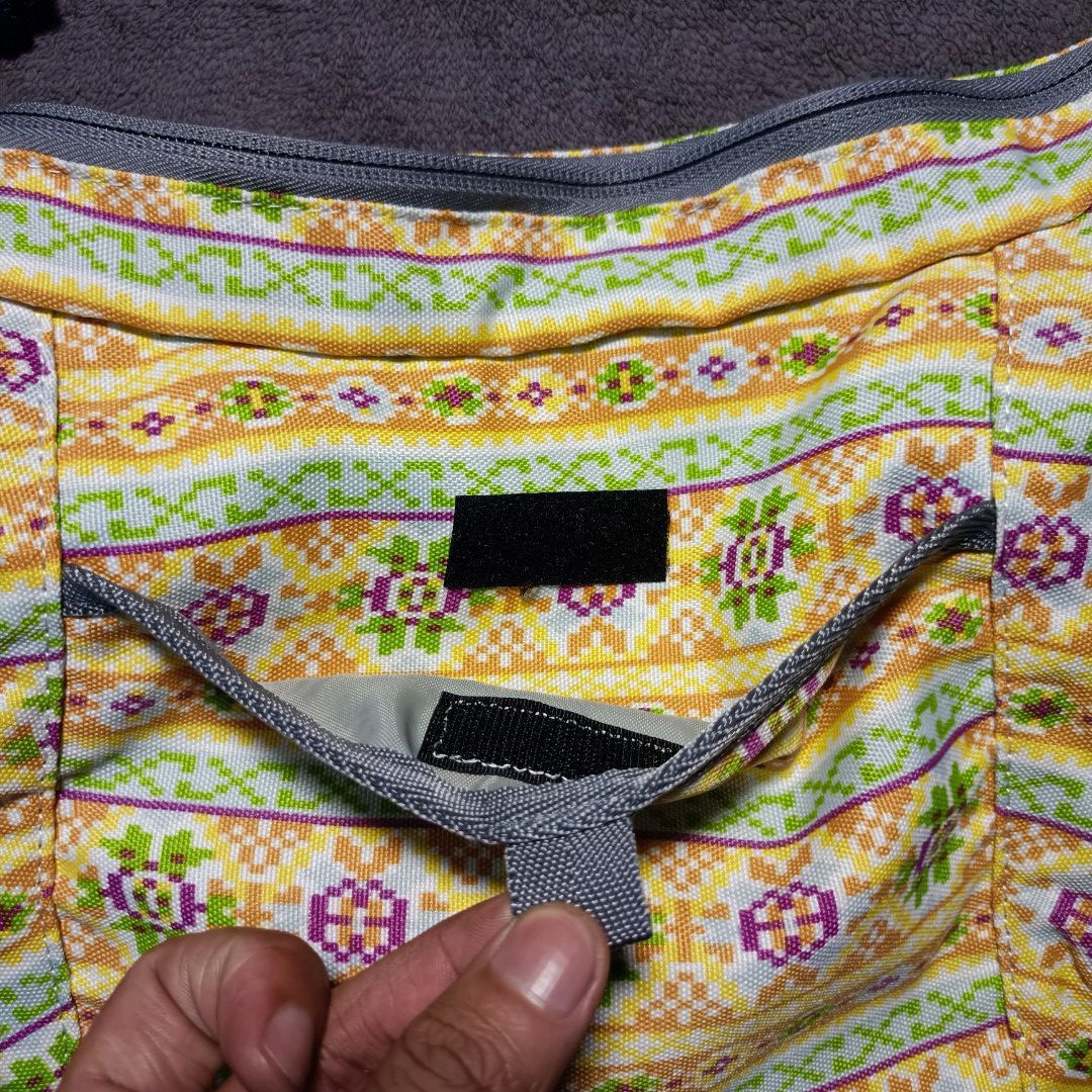 Columbia Patterned Crossbody Shoulder Bag (Category: Cross-body Bags) located in Manila. Submitted by nye.seller (Listing ID 1468531599, Image 3). Description: - Brand: Columbia - Style: Crossbody bag - Color/Pattern: Yellow with purple and green geometric prints, grey trim - Strap: Adjustable grey shoulder strap - Pockets: Front slip pocket with Velcro closure and inner zippered pocket - Compartment: Secure main zip compartment - Condition: Exce