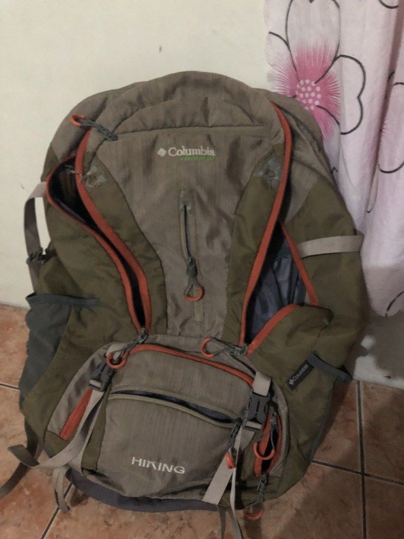 Columbia Titanium Hiking Backpack Outdoor Bag (Category: Backpacks) located in Manila. Submitted by warmstone_3189cf (Listing ID 1468599159, Image 2). Description: - Brand: Columbia Titanium - Color: Khaki and grey with orange zippers - Condition: Excellent, ready for the trail - Features: Multiple compartments, zipped front pockets, and adjustable straps - Comfort: Breathable mesh back panel and hip belt pockets for trail snacks - Ideal for: Cam