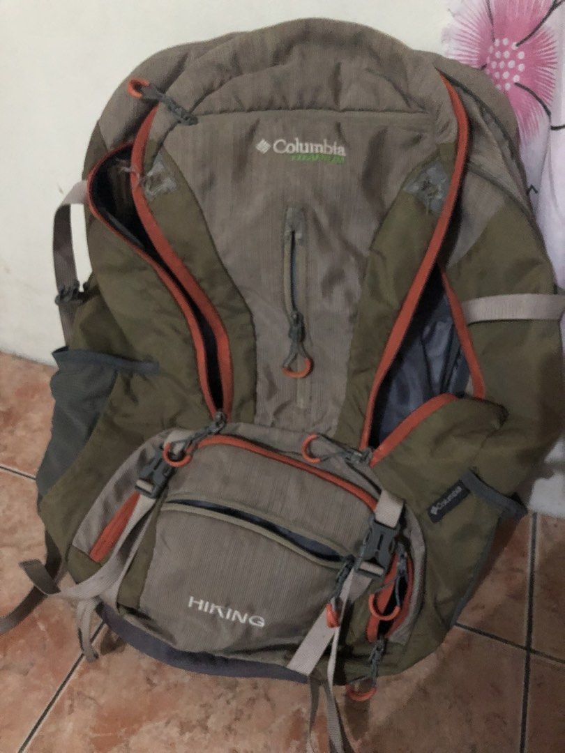 Columbia Titanium Hiking Backpack Outdoor Bag (Category: Backpacks) located in Manila. Submitted by warmstone_3189cf (Listing ID 1468599159, Image 1). Description: - Brand: Columbia Titanium - Color: Khaki and grey with orange zippers - Condition: Excellent, ready for the trail - Features: Multiple compartments, zipped front pockets, and adjustable straps - Comfort: Breathable mesh back panel and hip belt pockets for trail snacks - Ideal for: Cam
