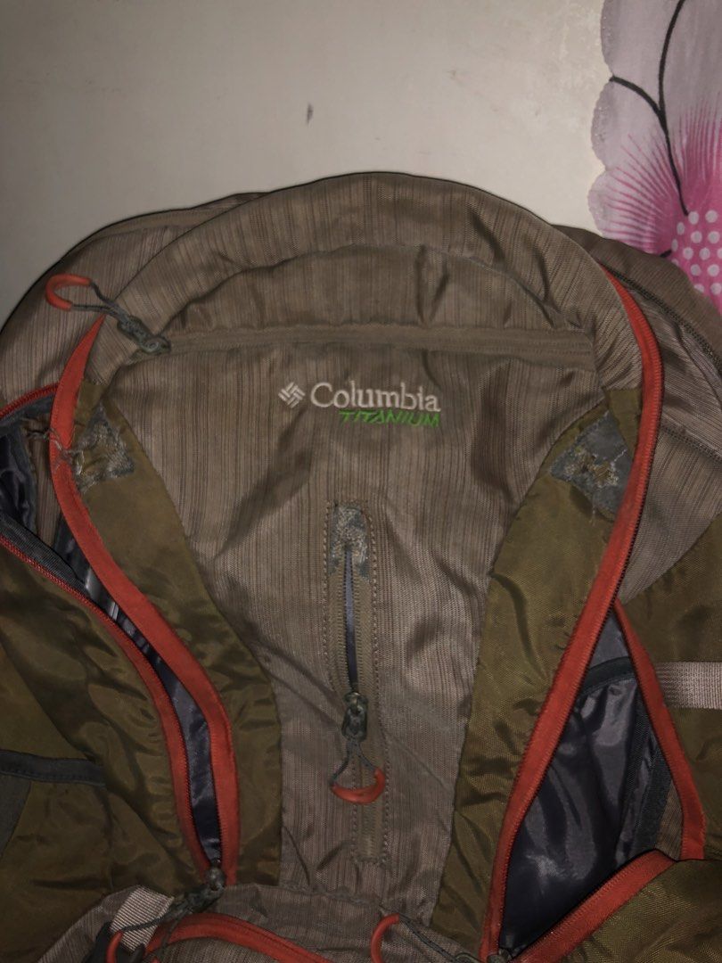 Columbia Titanium Hiking Backpack Outdoor Bag (Category: Backpacks) located in Manila. Submitted by warmstone_3189cf (Listing ID 1468599159, Image 3). Description: - Brand: Columbia Titanium - Color: Khaki and grey with orange zippers - Condition: Excellent, ready for the trail - Features: Multiple compartments, zipped front pockets, and adjustable straps - Comfort: Breathable mesh back panel and hip belt pockets for trail snacks - Ideal for: Cam