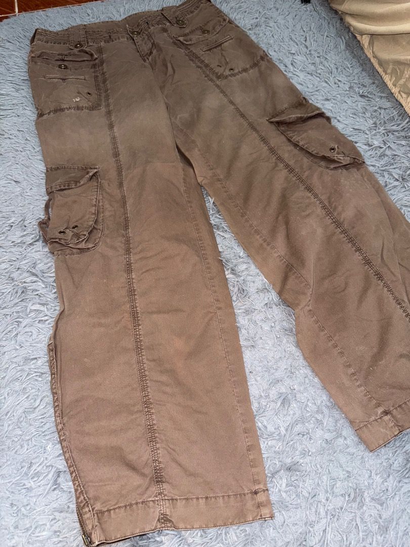 Combat Brown Cargo Y2K (Category: Jeans) located in Quezon City. Submitted by ashhaul (Listing ID 1468570359, Image 1). Description: - Brand/Model: Ltd Combat Brown Cargo Pants - Style: Heavy utility, rugged streetwear, relaxed fit - Pockets: Multiple functional pockets on legs and waist - Details: Button closures, reinforced stitching throughout - Hem: Adjustable zip hems at the ankles - Color: Earthy brown.