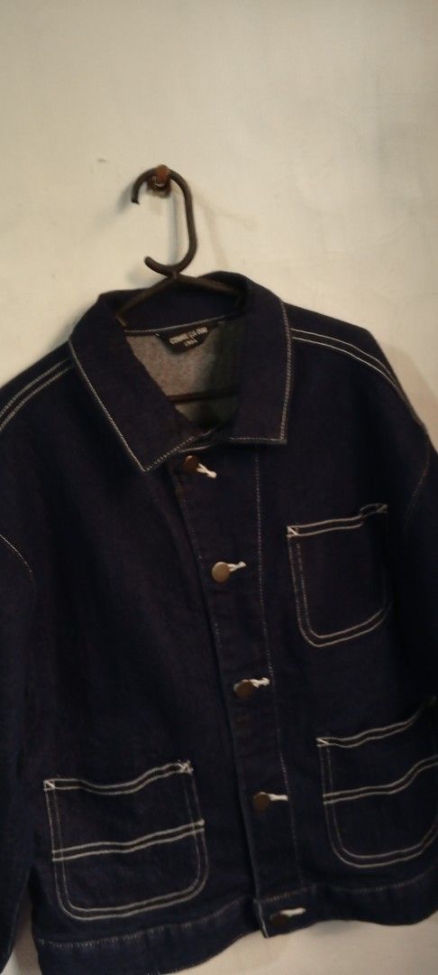 COMME CA ISM Dark Blue Denim Jacket (Category: Babies & Kids Fashion) located in Manila. Submitted by ezekislacl02490 (Listing ID 1468590835, Image 2). Description: - Brand: COMME CA ISM - Color: Dark blue denim with contrast white stitching - Material: Heavyweight cotton - Features: Multiple front utility pockets, metal buttons with white cord details, and classic collar - Fit: Relaxed fit with long sleeves and dark cuffs - Style: Vintage-inspir